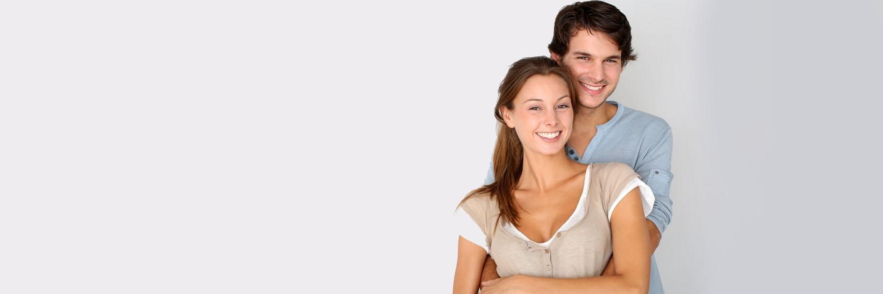 Young couple smiling & hugging l KOR Teeth Whitening Fayetteville AR