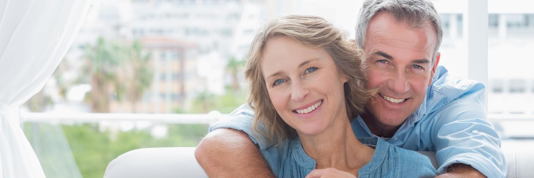 Older couple smiling holding each other l Cosmetic dentist Northwest Arkansas Family Dental