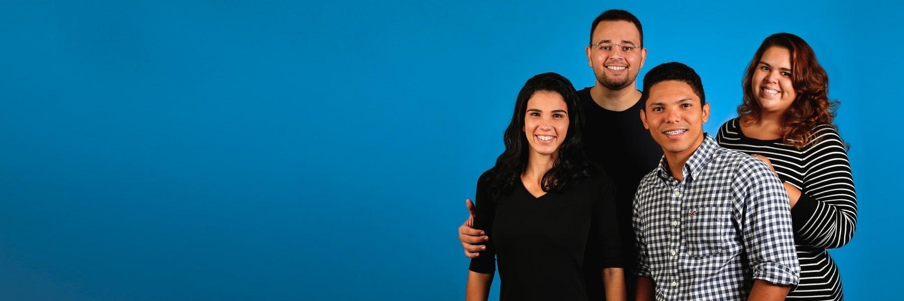 Family of four standing & smiling l Dental exam Fayetteville AR