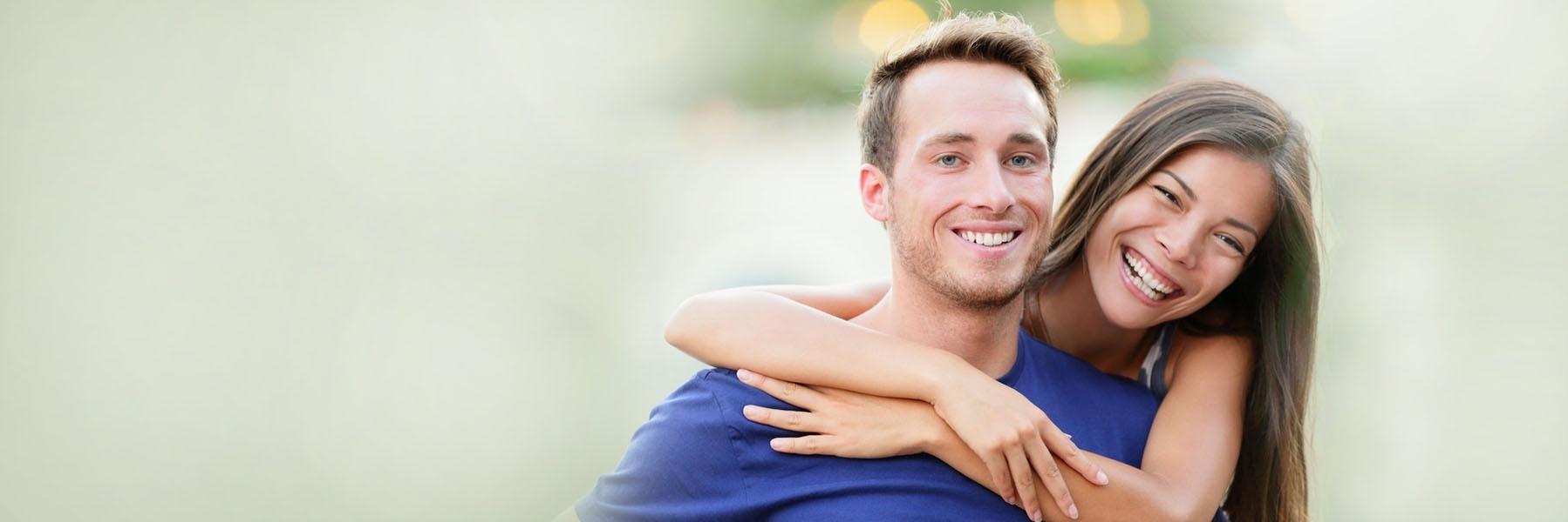 Young couple smiling & hugging l Northwest Arkansas Family Dental 