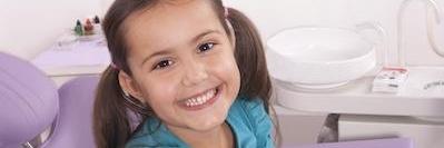 A child smiling during a dental visit using Dental Savings Plan in Fayetteville, AR