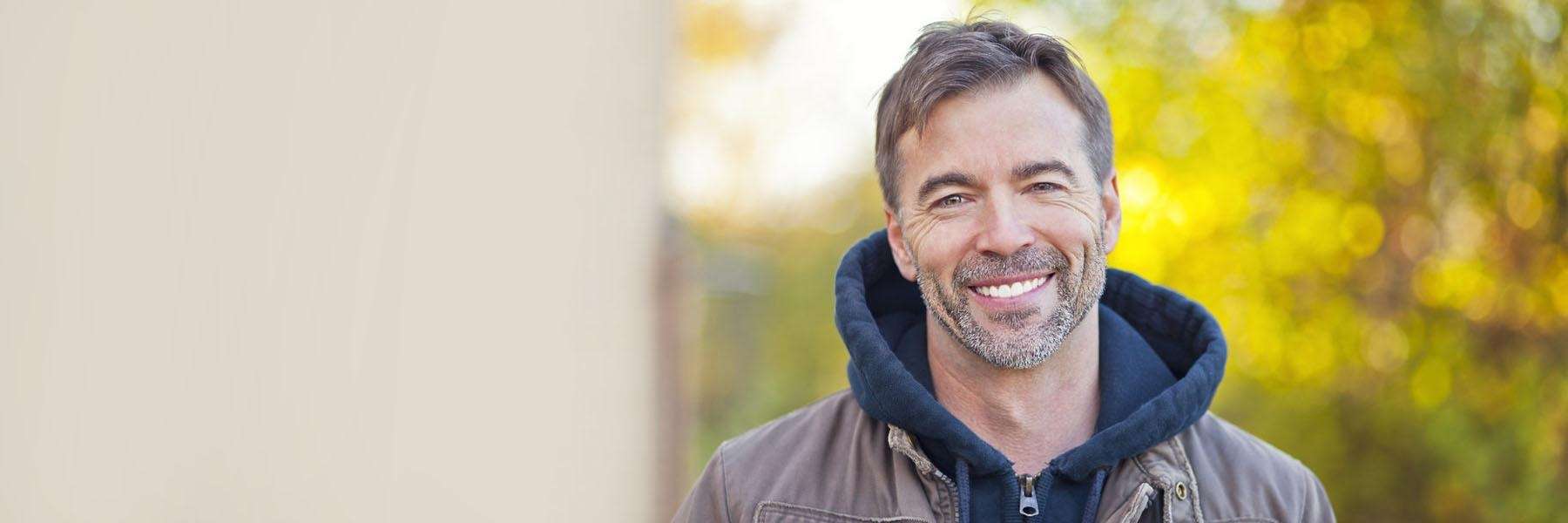 middle-aged man smiling confidently with dental BOTOX treatment in Fayetteville AR