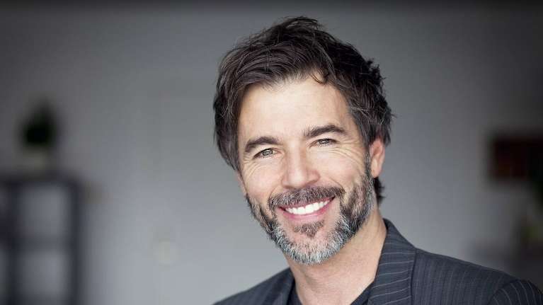 A man smiling after a getting Porcelain Veneers in Fayetteville, AR 
