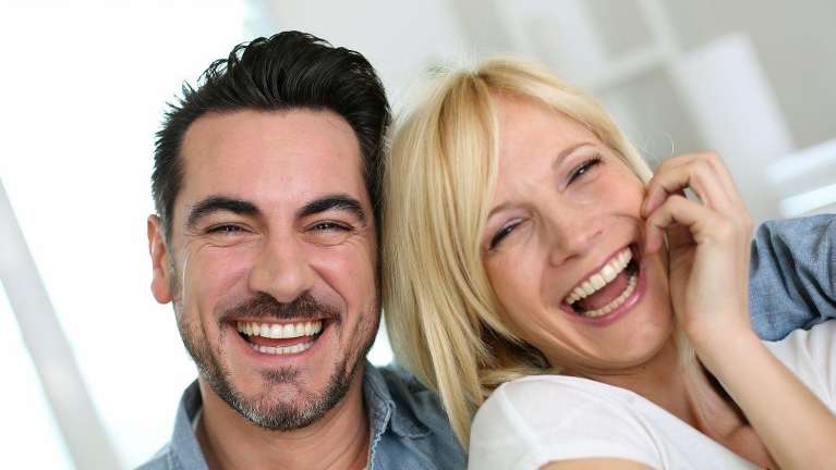 A couple smiling after getting Dental Veneers in Fayetteville