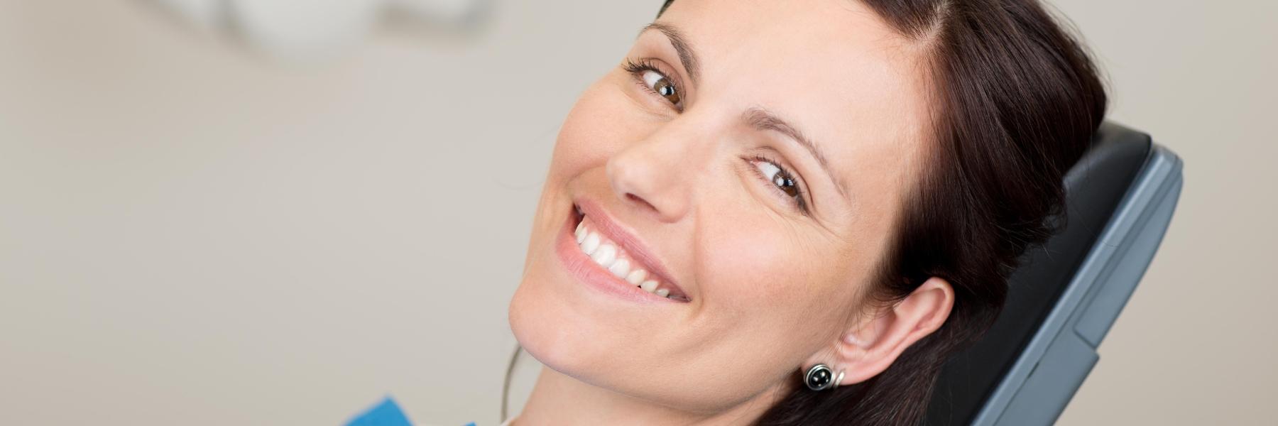 A woman smiling a cosmetic dentistal visit in Fayetteville, AR 