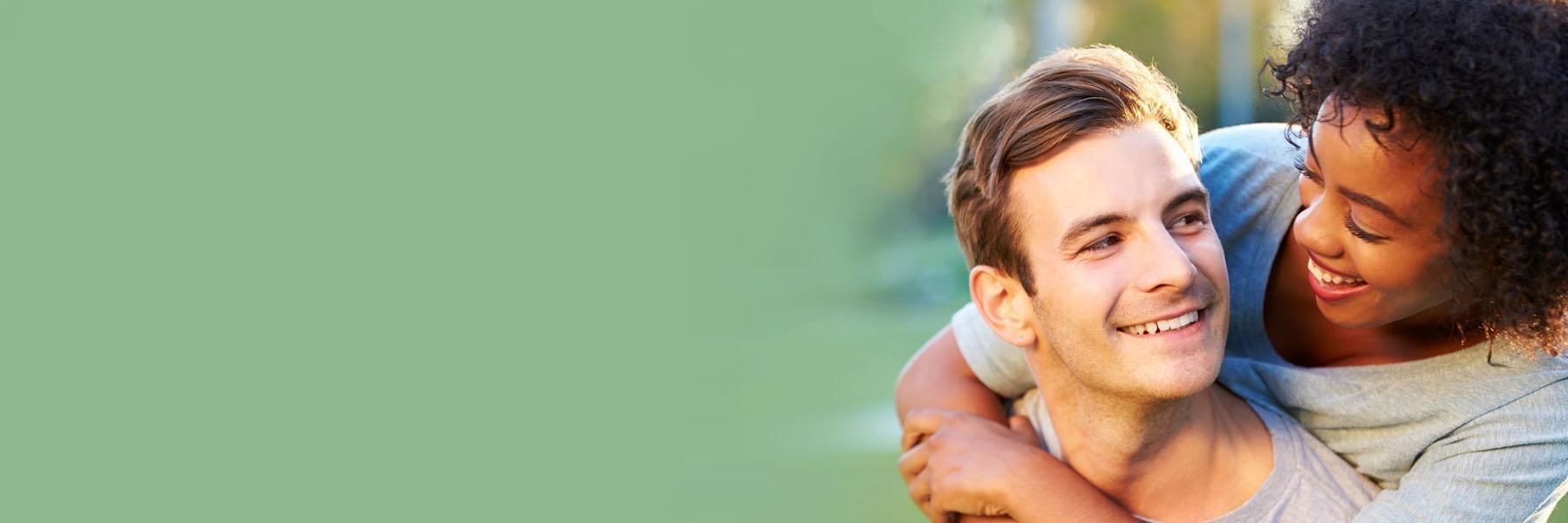 Young couple smiling & hugging l 72762 Full Mouth Reconstruction