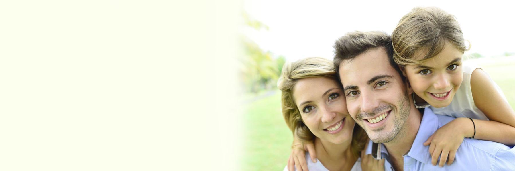 Family of three smiling & hugging l Family Dentist Fayetteville AR